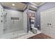 Modern bathroom with a walk-in shower, white marble tile, and linen closet at 901 Edgewater Dr, Garner, NC 27529