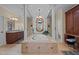 Elegant bathroom featuring a soaking tub with decorative columns and detailed woodwork throughout at 901 Edgewater Dr, Garner, NC 27529