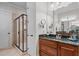 Bathroom with a granite countertop vanity, wood cabinets, and a glass-enclosed shower stall at 901 Edgewater Dr, Garner, NC 27529