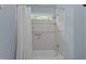 Bright bathroom features a tiled shower with a window for natural light at 901 Edgewater Dr, Garner, NC 27529
