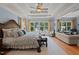 Spacious bedroom featuring a ceiling fan, recessed lighting, and sitting area with outside views at 901 Edgewater Dr, Garner, NC 27529