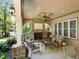 Covered patio features a stone fireplace, ceiling fan and comfortable seating at 901 Edgewater Dr, Garner, NC 27529