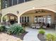 Covered patio with stone fireplace, comfortable seating, and outdoor dining at 901 Edgewater Dr, Garner, NC 27529