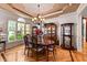 Charming dining room with a chandelier, hardwood floors, and display cabinets at 901 Edgewater Dr, Garner, NC 27529