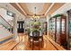 Elegant dining room with hardwood floors, a chandelier, and a view of the outdoors at 901 Edgewater Dr, Garner, NC 27529