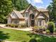 Beautiful house featuring stone, complementary siding, professional landscaping and a manicured lawn at 901 Edgewater Dr, Garner, NC 27529