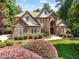 Attractive home with stone details, well-kept lawn and landscaping with blue sky backdrop at 901 Edgewater Dr, Garner, NC 27529