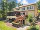 Expansive tan home features a screened porch, deck, and walkout basement at 901 Edgewater Dr, Garner, NC 27529