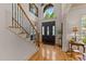 Grand foyer with hardwood floors, staircase, and a front door with sidelights at 901 Edgewater Dr, Garner, NC 27529