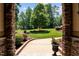 Stone entryway looks out to a landscaped front yard with mature trees at 901 Edgewater Dr, Garner, NC 27529