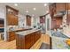 The kitchen features custom wood cabinets, granite counters, stainless appliances, and gas cooktop at 901 Edgewater Dr, Garner, NC 27529