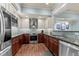 Modern kitchen with stainless steel appliances, dark wood floors, and light blue backsplash at 901 Edgewater Dr, Garner, NC 27529