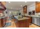 Spacious kitchen island with granite countertops, a sink, and a view of the dining area at 901 Edgewater Dr, Garner, NC 27529