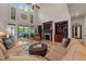 Bright living room with a fireplace, built-in bookshelves, and access to the outdoor patio at 901 Edgewater Dr, Garner, NC 27529
