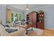 Cozy living room area features hardwood floors, a large window with natural light, and built in shelving at 901 Edgewater Dr, Garner, NC 27529