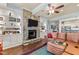 Spacious living room featuring a stone fireplace, custom bookshelves, and comfortable seating at 901 Edgewater Dr, Garner, NC 27529