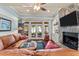 Bright living room with stone fireplace, doors to a patio, and comfortable leather seating at 901 Edgewater Dr, Garner, NC 27529