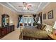 Luxurious main bedroom boasts a trey ceiling, plush bedding, and large windows offering ample natural light at 901 Edgewater Dr, Garner, NC 27529