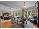 Bright and spacious main bedroom featuring large windows with lake views, a comfortable seating area, and hardwood floors at 901 Edgewater Dr, Garner, NC 27529