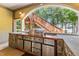Outdoor kitchen featuring a built-in grill, stainless steel drawers, and a staircase backdrop at 901 Edgewater Dr, Garner, NC 27529