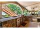 Well-appointed outdoor kitchen with built-in grill, stone accents, and a view of a staircase at 901 Edgewater Dr, Garner, NC 27529