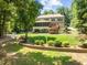 Spacious home featuring an enclosed porch, outdoor deck, and manicured lawn with lake views at 901 Edgewater Dr, Garner, NC 27529