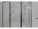 Modern glass-enclosed shower stall with tile surround, multiple shower heads, and recessed lighting at 901 Edgewater Dr, Garner, NC 27529
