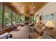 The sunroom has lots of windows, a ceiling fan, and a stone fireplace for comfort and relaxation at 901 Edgewater Dr, Garner, NC 27529