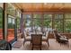 Inviting sunroom with wood-paneled ceilings, large windows, and a lake view, perfect for dining and relaxation at 901 Edgewater Dr, Garner, NC 27529