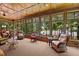 Spacious sunroom with expansive windows offering serene lake views and comfortable seating arrangements at 901 Edgewater Dr, Garner, NC 27529