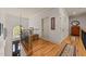 Upstairs hallway with hardwood floors, decorative art, and a view of the foyer at 901 Edgewater Dr, Garner, NC 27529