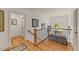 Upstairs hallway with hardwood floors, decorative art, and a view of the outdoors at 901 Edgewater Dr, Garner, NC 27529