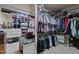 Spacious walk-in closet with custom shelving, drawers and ample hanging space for clothing storage at 901 Edgewater Dr, Garner, NC 27529