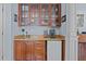 Wet bar area features beautiful wood cabinetry, a small sink, mini refrigerator, and coffee machine at 901 Edgewater Dr, Garner, NC 27529