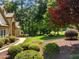 A beautiful yard with mature trees, vibrant landscaping and a glimpse of the house at 901 Edgewater Dr, Garner, NC 27529