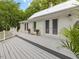 View of the back of the house, with a spacious deck and white siding at 967 Bynum Rd, Pittsboro, NC 27312