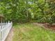 Landscaped backyard with a white picket fence at 967 Bynum Rd, Pittsboro, NC 27312
