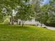 Backyard with a screened-in porch, landscaping, stairs and green grass at 967 Bynum Rd, Pittsboro, NC 27312