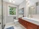 Modern bathroom featuring sleek vanity, vessel sink, and window with natural light at 967 Bynum Rd, Pittsboro, NC 27312