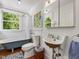 Bright bathroom with a clawfoot tub, unique sink, and stylish decor at 967 Bynum Rd, Pittsboro, NC 27312