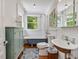 Well lit bath with a clawfoot tub and an ornate sink design at 967 Bynum Rd, Pittsboro, NC 27312