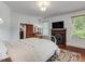 Bedroom with hardwood floors, fireplace, and natural light at 967 Bynum Rd, Pittsboro, NC 27312