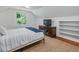 Cozy bedroom featuring natural light, neutral color palette, and built-in shelves with a media console at 967 Bynum Rd, Pittsboro, NC 27312