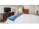 A bedroom showcasing hardwood flooring, a TV, and a built-in bookshelf, offering comfort and style at 967 Bynum Rd, Pittsboro, NC 27312