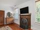 Bedroom with a decorative fireplace, television, wooden floors, and traditional dresser at 967 Bynum Rd, Pittsboro, NC 27312
