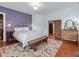 Bedroom with hardwood floors, colorful rug, natural light at 967 Bynum Rd, Pittsboro, NC 27312