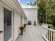 Spacious deck with grill, potted plants, and white railing, perfect for outdoor entertaining at 967 Bynum Rd, Pittsboro, NC 27312