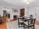 Dining room with hardwood floors, fireplace, and adjacent access to the kitchen at 967 Bynum Rd, Pittsboro, NC 27312