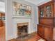 Dining room featuring fireplace, hardwood floors, china cabinet and abstract art at 967 Bynum Rd, Pittsboro, NC 27312