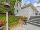Picturesque home exterior, showcasing the backyard, stairs to the deck, and lush landscaping at 967 Bynum Rd, Pittsboro, NC 27312